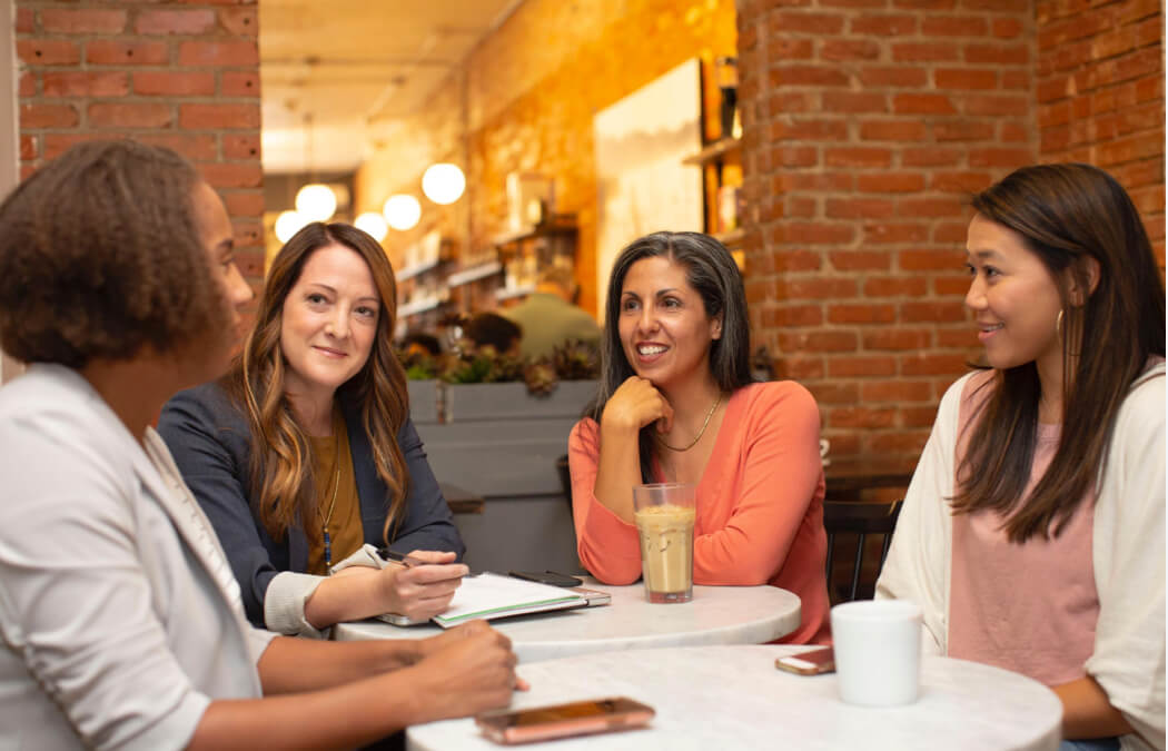 people gathered around table talking