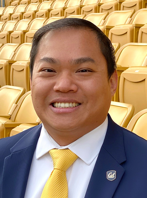 Headshot of Jonathon Chew in front of yellow stadium seats