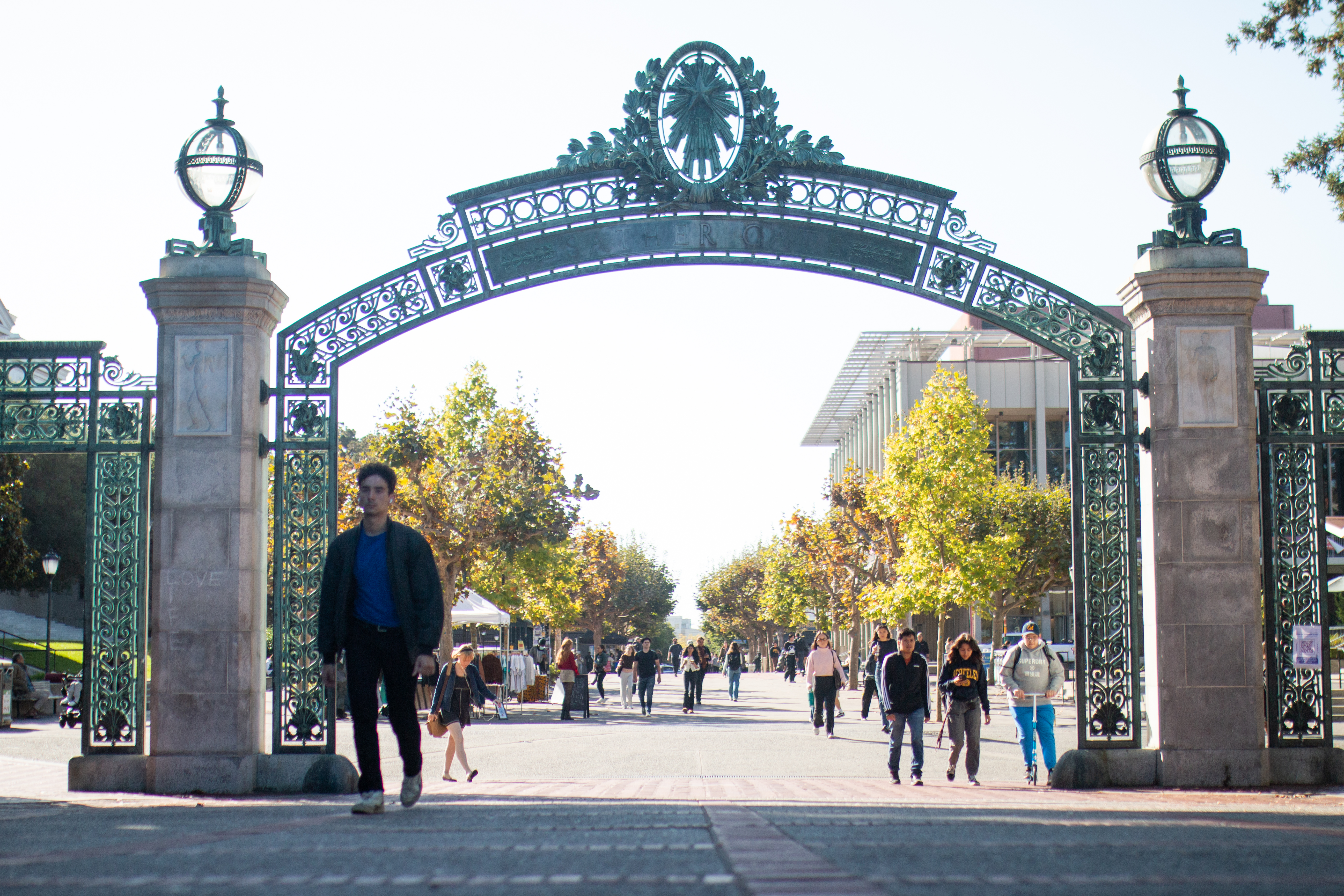 Students walk on UC Berkeley's campus through Sather Gate.