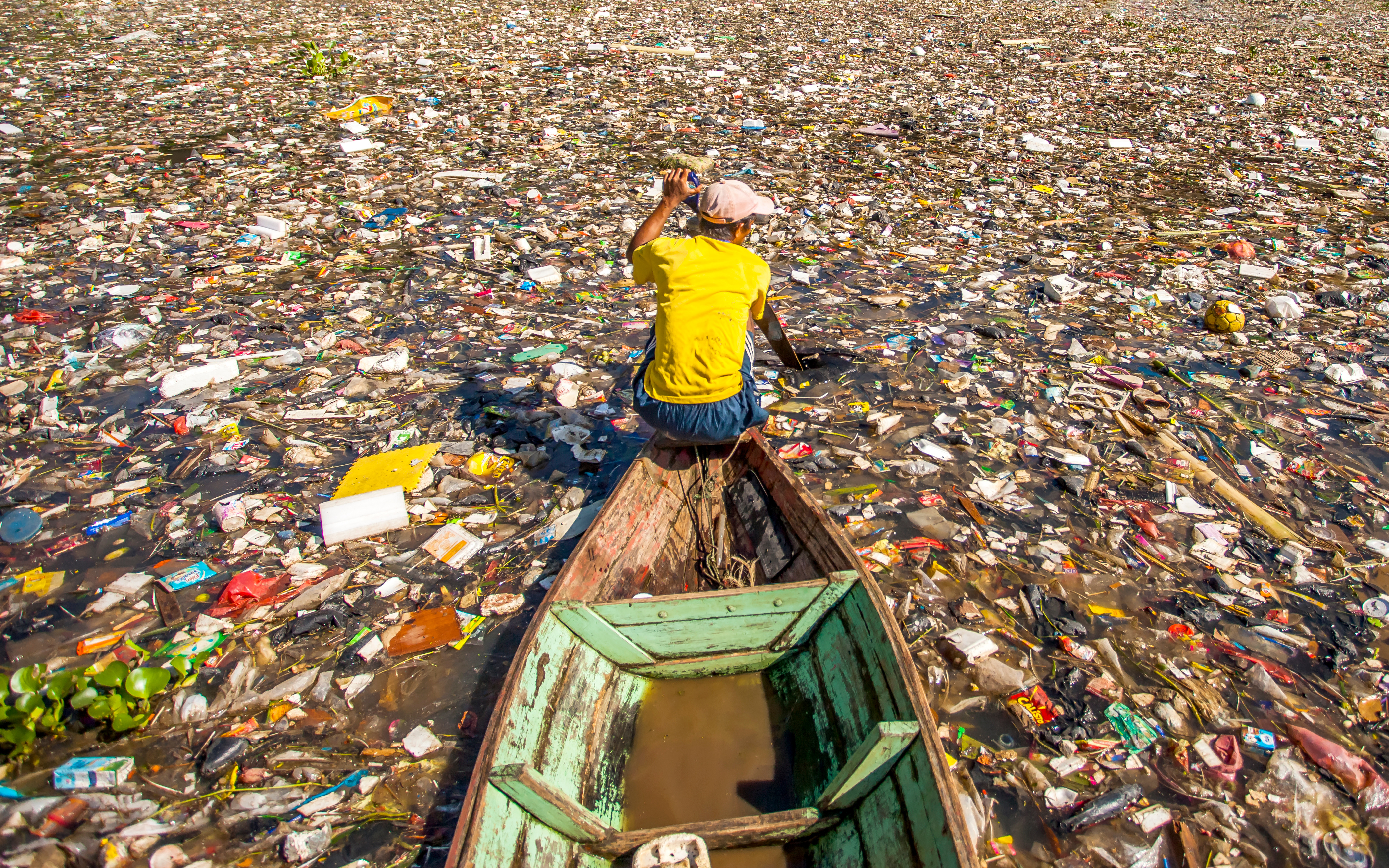 People collect trash that can be recycled and traded from the sea of garbage in the Citarum River, the one of polluted river in Bandung, West Java, Indonesia.