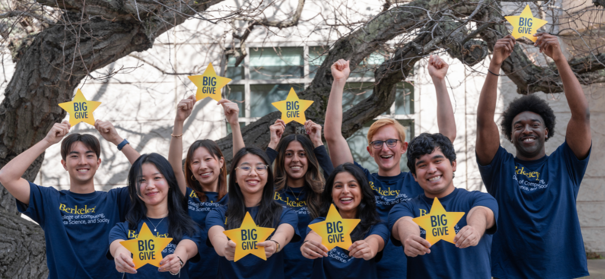 Students in CDSS t-shirts holding Big Give stars