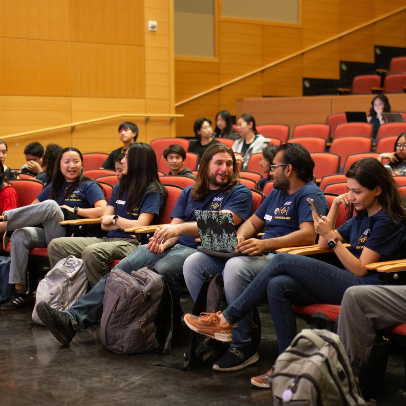 Data Science students talk together in a lecture hall