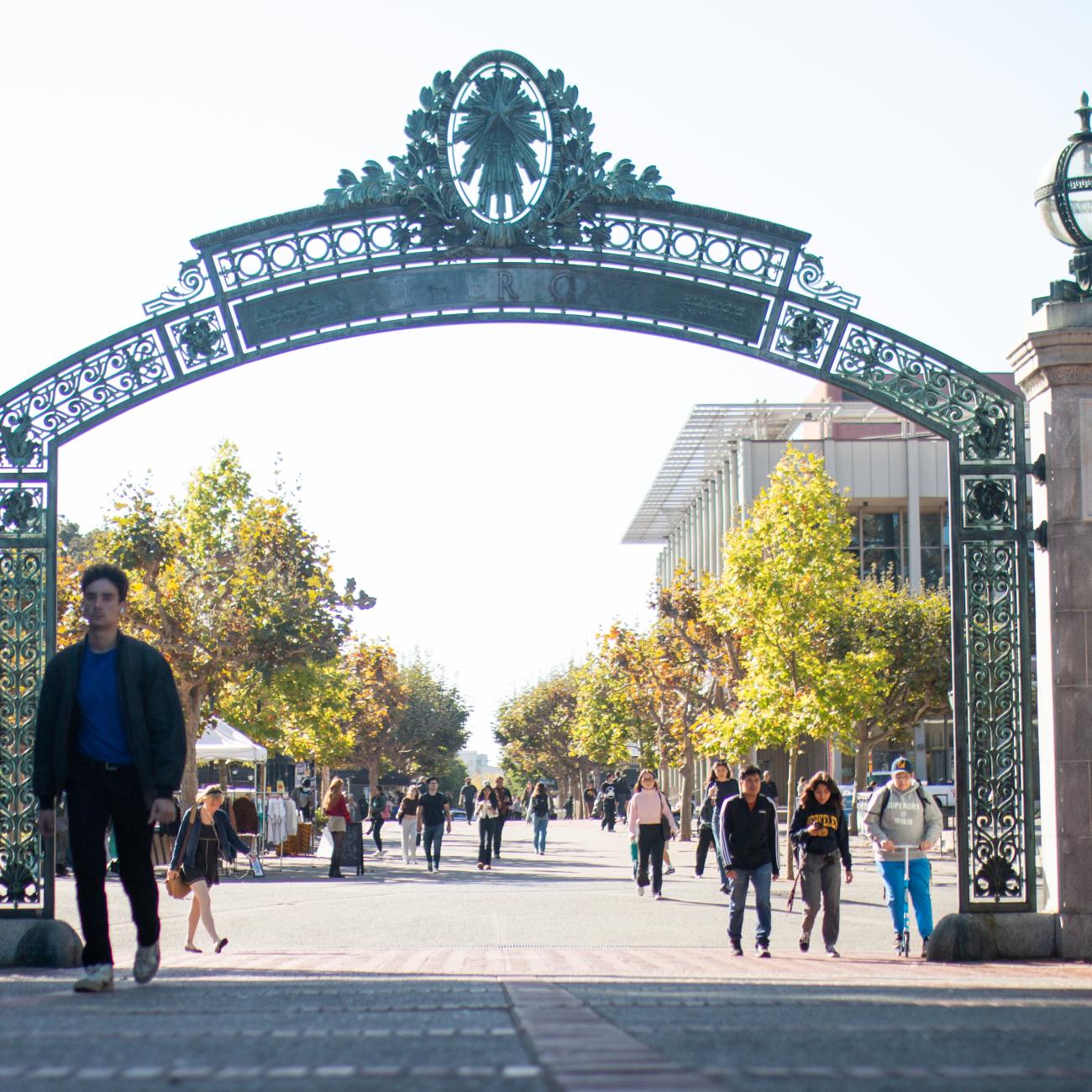 Students walk on UC Berkeley's campus through Sather Gate.