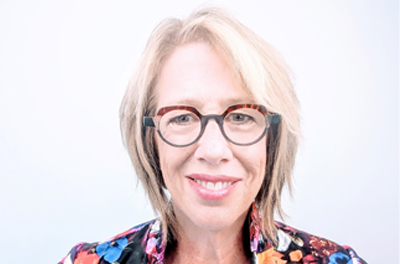 Portrait of Mary Lou Jepson smiling against a white background