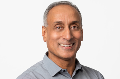 Portrait of Prabhakar Raghavan smiling against a white background