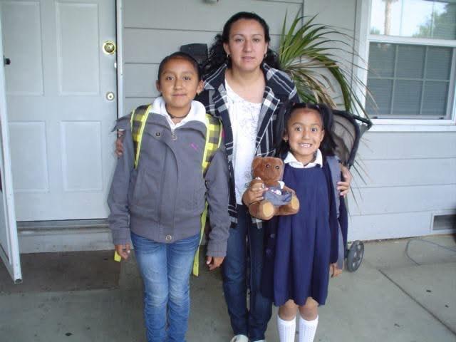 Gonzalez Perez's mother (center) readies her daughters for school (Fatima on left, younger sister Carol on right) after being separated for two weeks at the U.S./Mexico border