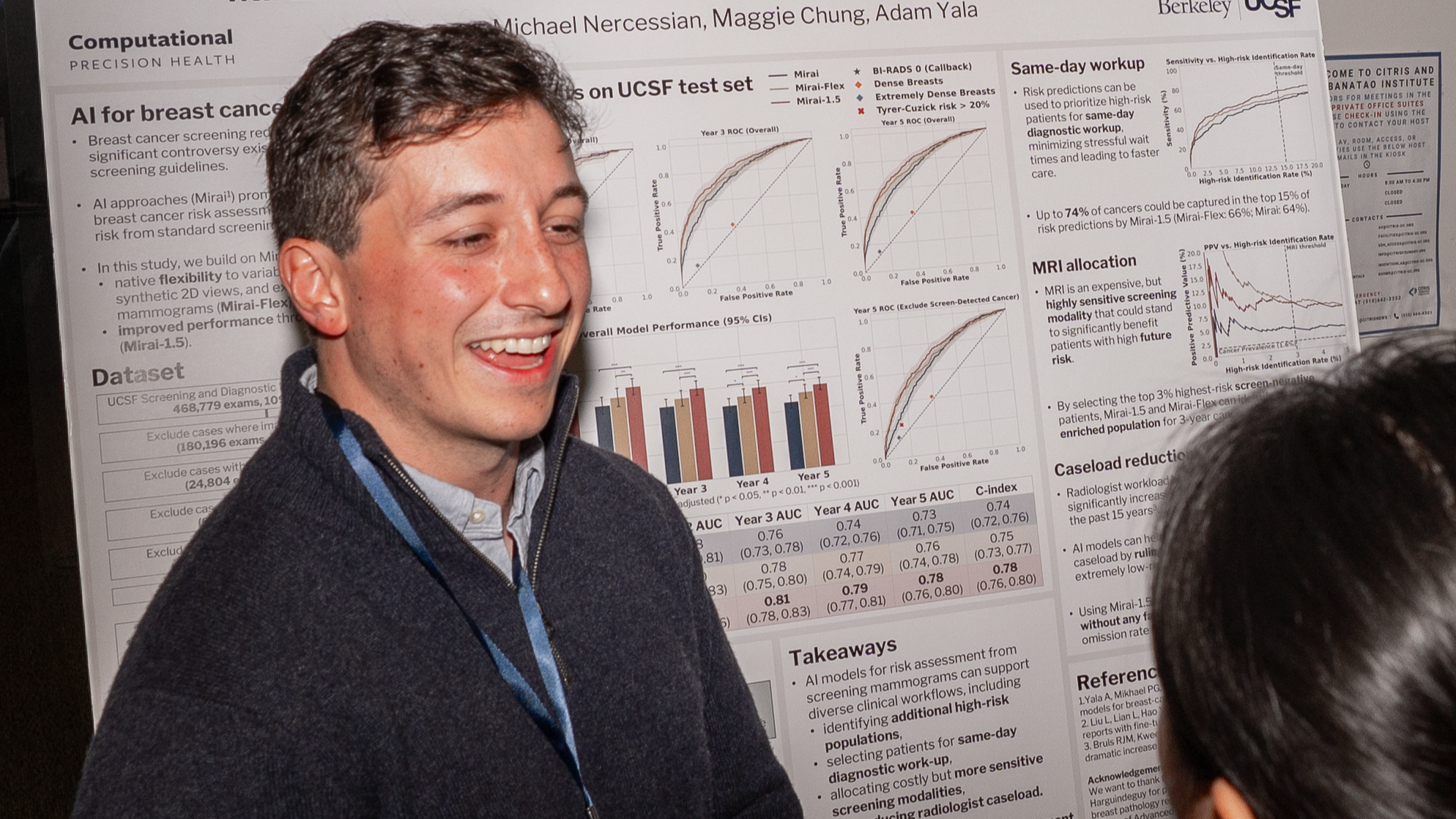 Michael Nercessian discusses his poster with a conference attendee