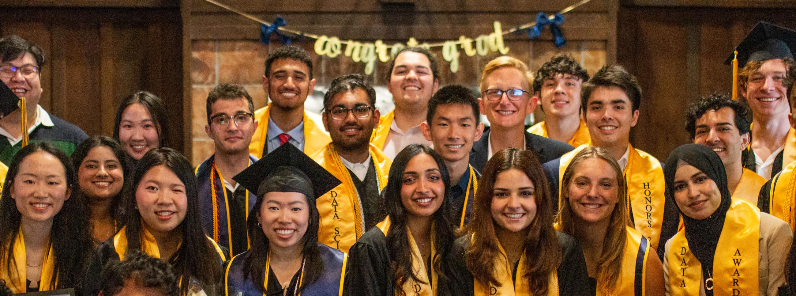 honors graduates pose with gold cords