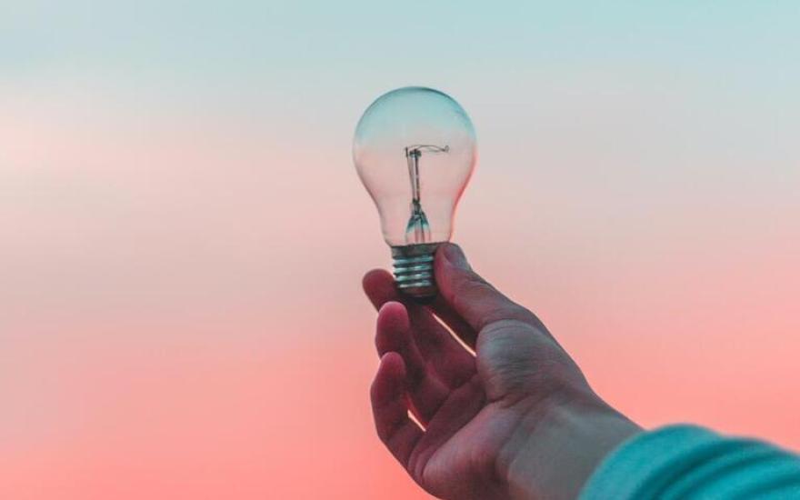 hand holding lightbulb