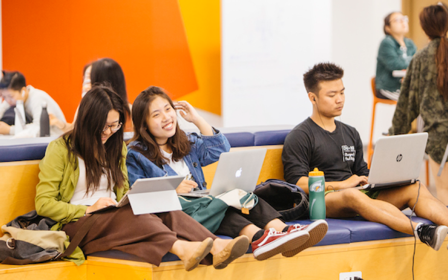 Three students sitting on couch in Moffitt Library