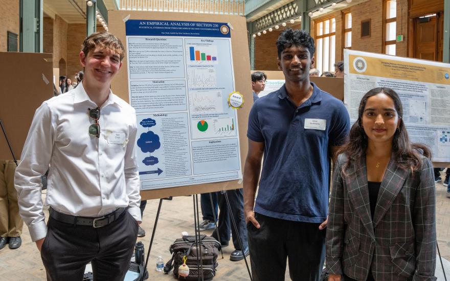 Students showing research at a poster session