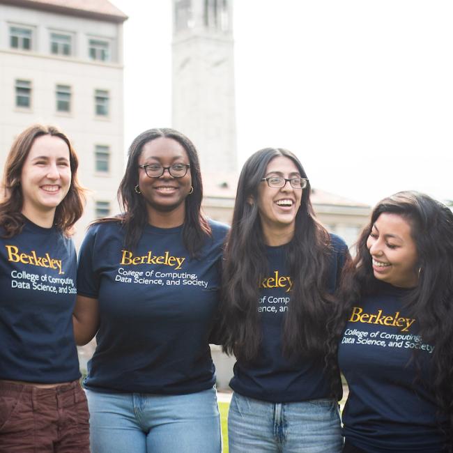 Students smile in front of the Campanile on the UC Berkeley campus.